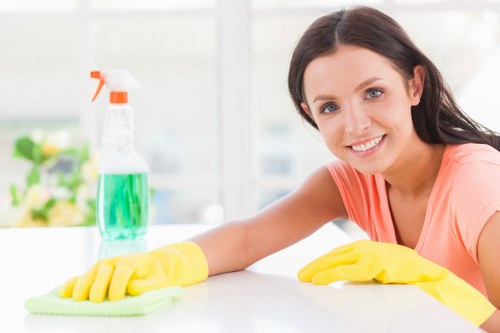 Carpet cleaning technician preparing equipment safely in a home