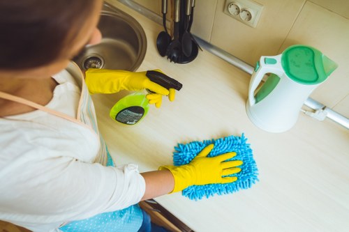 Technician using upholstery cleaning equipment on a chair